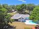 Aerial view of backyard with pool, mature trees, privacy fence, and screened in patio at 2204 Jennifer Ln, Valrico, FL 33594