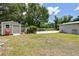 Backyard with shed and mature trees, offering ample space for outdoor activities at 2204 Jennifer Ln, Valrico, FL 33594