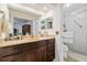 Well-lit bathroom features a dark wood vanity with ample storage and a glass enclosed shower at 2204 Jennifer Ln, Valrico, FL 33594