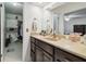 A bathroom with a vanity and sink and an adjacent walk-in closet at 2204 Jennifer Ln, Valrico, FL 33594