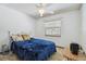Cozy bedroom with ceiling fan and a window bringing in natural light at 2204 Jennifer Ln, Valrico, FL 33594