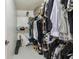 Walk-in closet features ample storage space with shelving and hanging areas at 2204 Jennifer Ln, Valrico, FL 33594