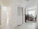 The hallway leads to the dining room with a chandelier and dining table with seating at 2204 Jennifer Ln, Valrico, FL 33594