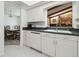 Bright kitchen featuring white cabinets, modern appliances, and a view into the dining room at 2204 Jennifer Ln, Valrico, FL 33594