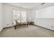 Cozy living room features neutral carpet, a bright window, and a stylish decor at 2204 Jennifer Ln, Valrico, FL 33594