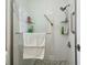 The renovated shower features glass doors, shelving, and modern fixtures at 2204 Jennifer Ln, Valrico, FL 33594