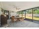 Enclosed lanai with wicker chairs and table and access to the backyard at 2204 Jennifer Ln, Valrico, FL 33594