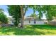 Well-maintained backyard exterior of the house with a grassy lawn and mature landscaping at 2314 50Th E Dr, Bradenton, FL 34203