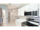 Bright eat-in kitchen with stainless steel appliances, white cabinetry, and tile flooring at 2314 50Th E Dr, Bradenton, FL 34203