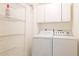 Laundry room area with washer, dryer, shelving, and overhead storage at 2314 50Th E Dr, Bradenton, FL 34203