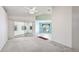 Bright living room with vaulted ceilings, sliding doors, and an adjacent dining area offers versatile space at 2314 50Th E Dr, Bradenton, FL 34203