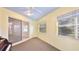Enclosed porch sunroom featuring a ceiling fan and natural light at 2314 50Th E Dr, Bradenton, FL 34203