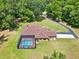 Lovely home featuring a screened-in pool, set amidst verdant landscaping at 24498 Casey Rd, Brooksville, FL 34601