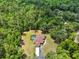 Estate nestled among lush greenery, featuring a screened-in pool and extended driveway at 24498 Casey Rd, Brooksville, FL 34601