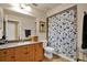 Bathroom featuring wood cabinets, granite counters, and shower-tub combo at 24498 Casey Rd, Brooksville, FL 34601