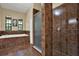 The bathroom has a soaker tub and glass-enclosed shower at 24498 Casey Rd, Brooksville, FL 34601