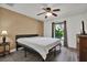Comfortable bedroom with a neutral palette, a large window, and sleek wood-look flooring at 24498 Casey Rd, Brooksville, FL 34601