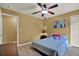 Bedroom featuring bright wall art, plush pillows, and wood-look flooring at 24498 Casey Rd, Brooksville, FL 34601