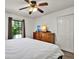 Cozy bedroom with natural light, wood flooring, dresser and ample closet space at 24498 Casey Rd, Brooksville, FL 34601