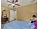 Bedroom featuring wood-look floors, dresser with mirror, and wall art at 24498 Casey Rd, Brooksville, FL 34601