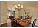 Dining room with wood table and chairs, chandelier, and view of the kitchen at 24498 Casey Rd, Brooksville, FL 34601