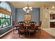 Dining room with wood table and chairs, chandelier, and large window at 24498 Casey Rd, Brooksville, FL 34601