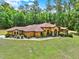 Charming one-story home with a sprawling lawn and lush landscaping at 24498 Casey Rd, Brooksville, FL 34601