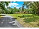 Charming stucco home surrounded by mature trees, set back on a large lot at 24498 Casey Rd, Brooksville, FL 34601