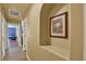 A hallway with an arched alcove featuring artwork leads to a bedroom with two beds at 24498 Casey Rd, Brooksville, FL 34601