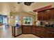 Kitchen featuring granite countertops, stainless steel appliances, dark cabinets, and backyard view at 24498 Casey Rd, Brooksville, FL 34601