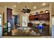 Kitchen island with granite countertops, stainless steel appliances, dark cabinets, and overhead fan at 24498 Casey Rd, Brooksville, FL 34601