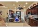 Kitchen island with granite countertops, stainless steel appliances, dark cabinets, and backsplash at 24498 Casey Rd, Brooksville, FL 34601