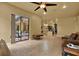 Open-concept living room with tile floors, a sliding glass door to the patio, and a view of the kitchen at 24498 Casey Rd, Brooksville, FL 34601