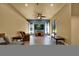 Bright living room with tile floors, a ceiling fan, and a comfortable seating area with large windows at 24498 Casey Rd, Brooksville, FL 34601