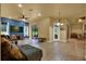 Comfortable living room with tile floors, a television, and access to an outdoor patio at 24498 Casey Rd, Brooksville, FL 34601