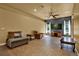 Spacious living room features tile flooring, ceiling fan, and a dark accent wall with entertainment center at 24498 Casey Rd, Brooksville, FL 34601