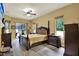 The main bedroom features wood floors, a ceiling fan, and an exterior door to the backyard at 24498 Casey Rd, Brooksville, FL 34601