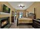A main bedroom features a fireplace, dark wood accents, and a door to the outside patio at 24498 Casey Rd, Brooksville, FL 34601