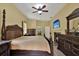 The main bedroom has a fireplace, dark wood accents, and a door to the ensuite bathroom at 24498 Casey Rd, Brooksville, FL 34601
