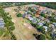 Stunning aerial view of a golf course home with a shimmering lake and lush greenery creating a serene backdrop at 30314 Fairway Dr, Wesley Chapel, FL 33543
