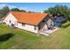 Expansive backyard with a screened pool area, tile roof, and ample lawn space for outdoor enjoyment at 30314 Fairway Dr, Wesley Chapel, FL 33543