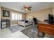 Comfortable bedroom featuring a ceiling fan, plantation shutters, and a built-in desk at 30314 Fairway Dr, Wesley Chapel, FL 33543
