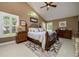 Bedroom with a vaulted ceiling, plantation shutters, and classic decor at 30314 Fairway Dr, Wesley Chapel, FL 33543