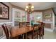 Elegant dining room with chandelier, pool view, and plantation shutters at 30314 Fairway Dr, Wesley Chapel, FL 33543