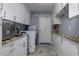 Convenient laundry room with white cabinets and granite countertops at 30314 Fairway Dr, Wesley Chapel, FL 33543