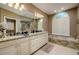 Spacious main bathroom with dual vanities, bathtub, and tile accents at 30314 Fairway Dr, Wesley Chapel, FL 33543