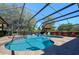 Gorgeous screened in pool and spa with chairs and umbrella at 30314 Fairway Dr, Wesley Chapel, FL 33543