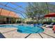 Beautiful screened pool area with lounge chairs, spa and covered patio at 30314 Fairway Dr, Wesley Chapel, FL 33543
