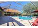 Sparkling screened pool with brick paved deck and views of house and backyard at 30314 Fairway Dr, Wesley Chapel, FL 33543