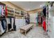 Spacious walk-in closet featuring custom shelving, drawers, and bench seating at 30314 Fairway Dr, Wesley Chapel, FL 33543